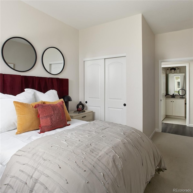 carpeted bedroom featuring a closet and baseboards