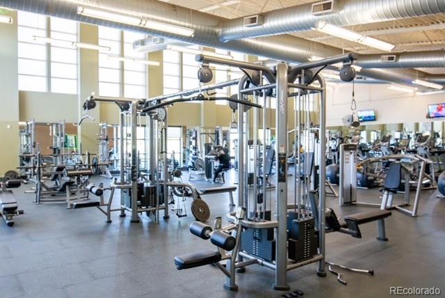 exercise room featuring a towering ceiling