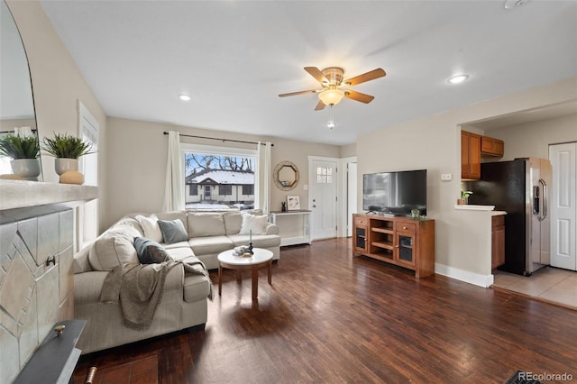 living room featuring wood-type flooring and ceiling fan