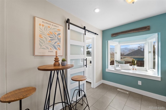 tiled dining area with a barn door