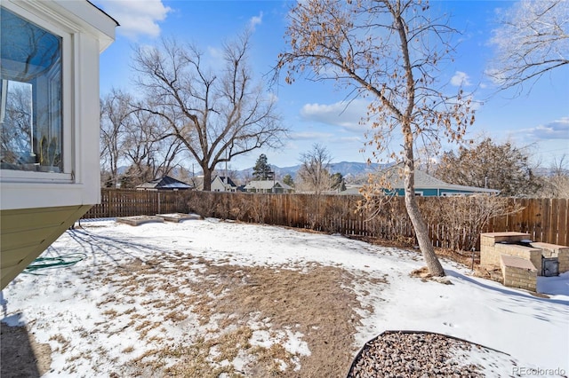 snowy yard featuring a mountain view