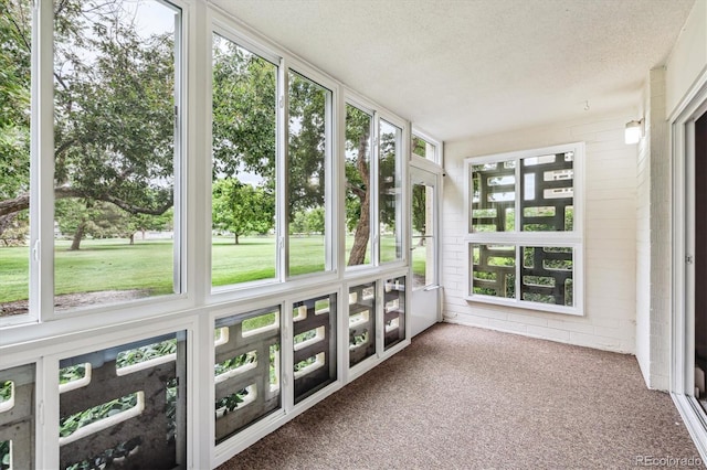 650 S Alton Way Unit 10A, Denver, CO 80247 - unfurnished sunroom featuring carpet and a textured ceiling
