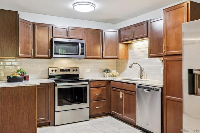 650 S Alton Way Unit 10A, Denver, CO 80247 - kitchen featuring stainless steel appliances, a sink, tasteful backsplash, and light stone countertops