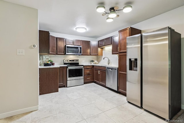 650 S Alton Way Unit 10A, Denver, CO 80247 - kitchen with stainless steel appliances, light countertops, decorative backsplash, and a sink