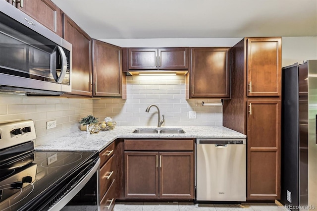 650 S Alton Way Unit 10A, Denver, CO 80247 - kitchen featuring stainless steel appliances, a sink, light stone counters, and backsplash