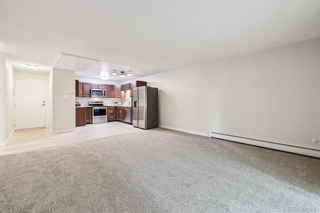 650 S Alton Way Unit 10A, Denver, CO 80247 - unfurnished living room with light carpet, baseboards, baseboard heating, and light tile patterned flooring