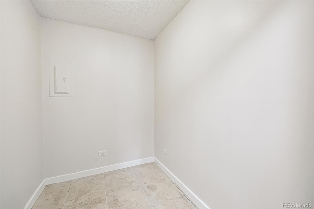 650 S Alton Way Unit 10A, Denver, CO 80247 - empty room featuring baseboards and a textured ceiling
