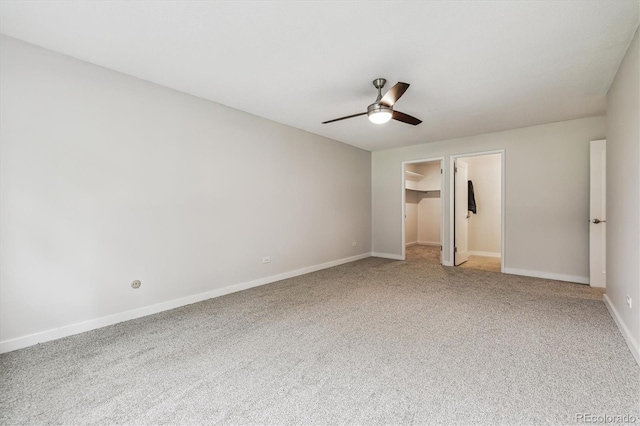 650 S Alton Way Unit 10A, Denver, CO 80247 - unfurnished bedroom with carpet flooring, a walk in closet, baseboards, a ceiling fan, and a closet