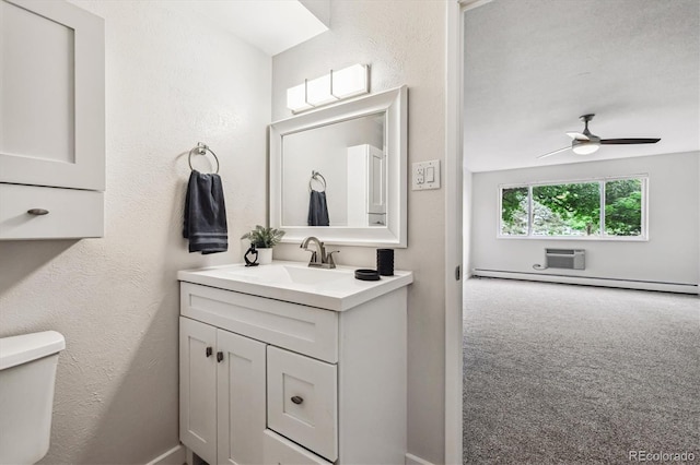 650 S Alton Way Unit 10A, Denver, CO 80247 - bathroom featuring toilet, vanity, a ceiling fan, baseboard heating, and a wall mounted AC