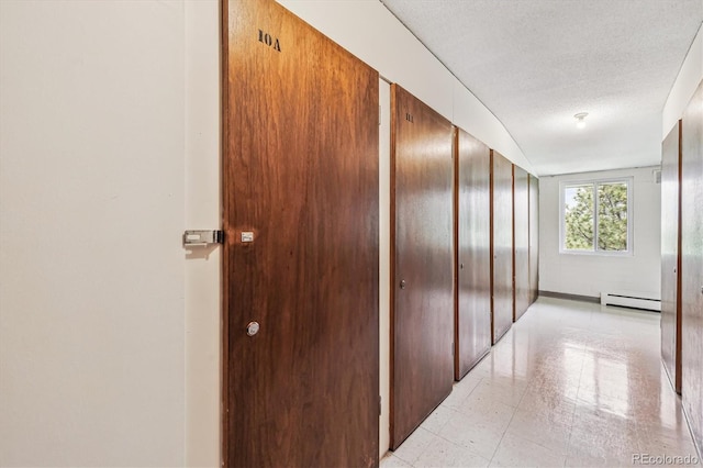 650 S Alton Way Unit 10A, Denver, CO 80247 - corridor featuring baseboard heating and a textured ceiling