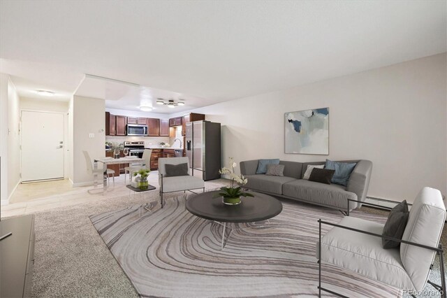 650 S Alton Way Unit 10A, Denver, CO 80247 - living room featuring baseboard heating, light tile patterned floors, and baseboards