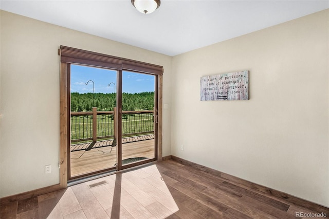 unfurnished room with wood-type flooring