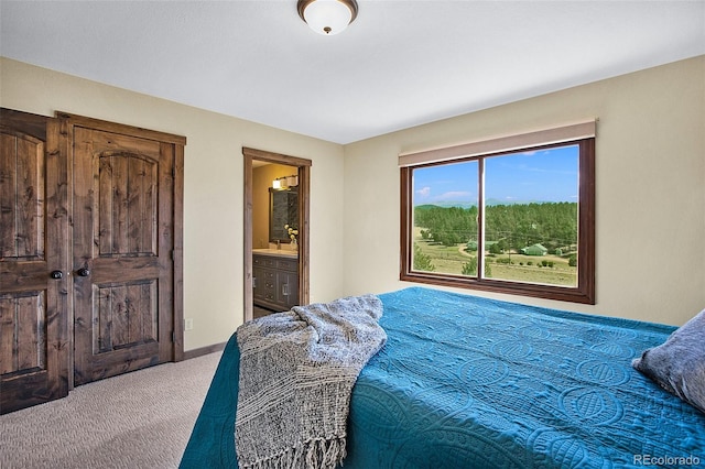 carpeted bedroom with connected bathroom