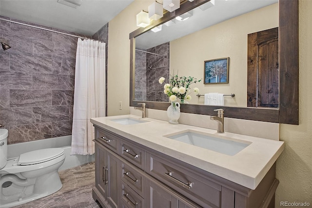 full bathroom featuring vanity, shower / bath combo, and toilet