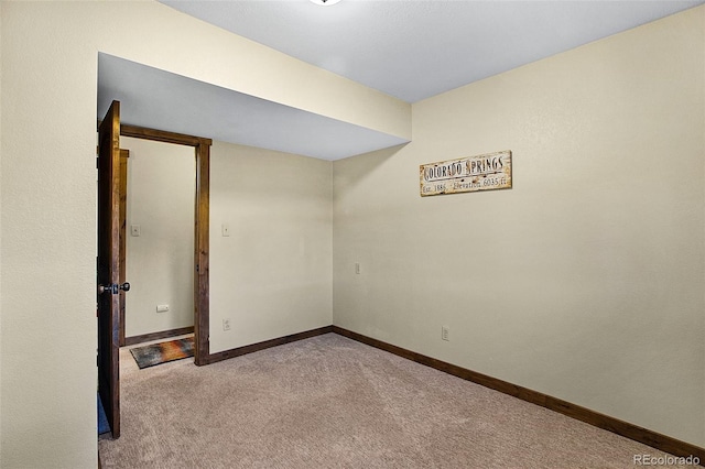 unfurnished room featuring light colored carpet