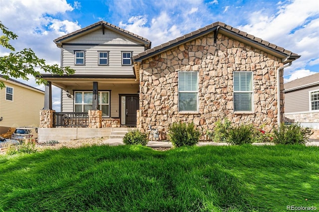 view of front of property with covered porch and a front yard