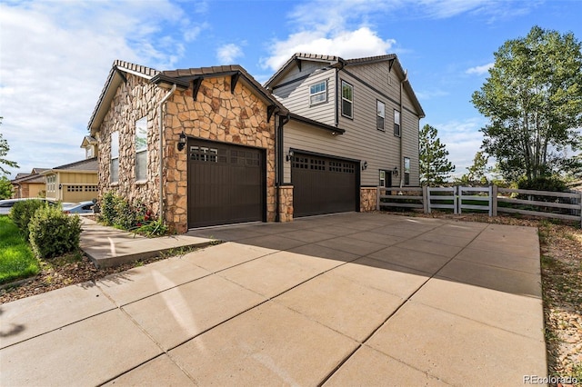 view of side of home featuring a garage