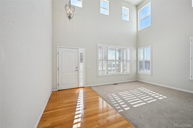 entryway featuring a healthy amount of sunlight, a high ceiling, and hardwood / wood-style floors