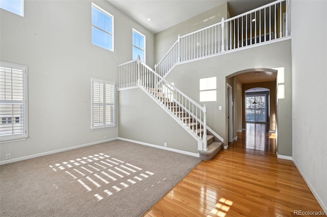 entryway with hardwood / wood-style flooring and a high ceiling