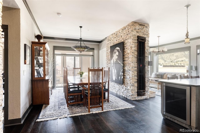 dining space with dark wood finished floors, wine cooler, a wealth of natural light, and ornamental molding