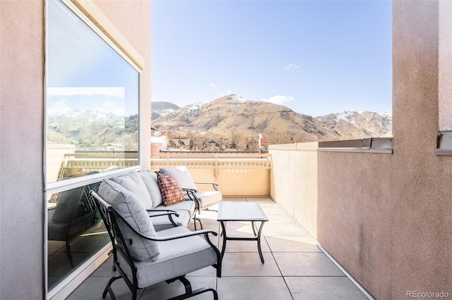 balcony featuring an outdoor living space and a mountain view