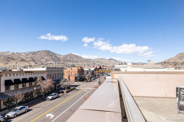 exterior space with sidewalks, a mountain view, and curbs