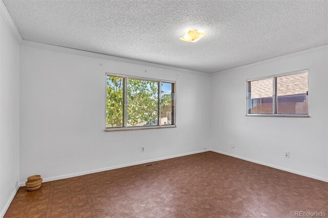 207 Autobee Ln, Avondale, CO 81022 - unfurnished room with a textured ceiling, ornamental molding, and baseboards