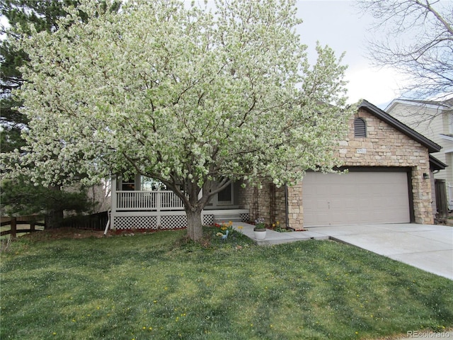 10522 Stoneflower Dr, Parker, CO 80134 - view of property hidden behind natural elements featuring stone siding, a garage, concrete driveway, and covered porch