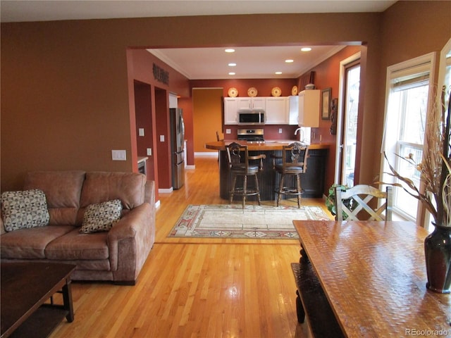 10522 Stoneflower Dr, Parker, CO 80134 - living room featuring light wood finished floors, recessed lighting, and crown molding