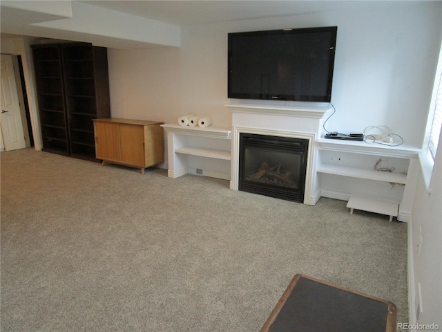 10522 Stoneflower Dr, Parker, CO 80134 - unfurnished living room featuring carpet floors and a glass covered fireplace