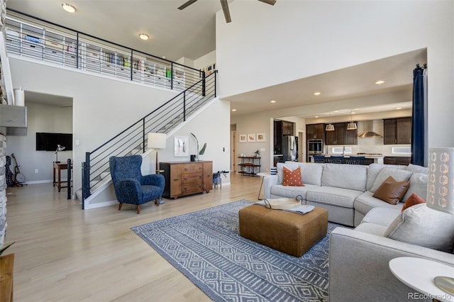 10024 Waterton Canyon Way, Colorado Springs, CO 80924 - living room with a towering ceiling, recessed lighting, stairway, a ceiling fan, and light wood finished floors