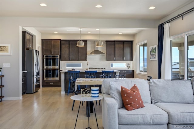 10024 Waterton Canyon Way, Colorado Springs, CO 80924 - living room featuring recessed lighting, light wood-style floors, and baseboards