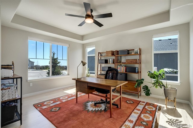 10024 Waterton Canyon Way, Colorado Springs, CO 80924 - office with a tray ceiling, ceiling fan, wood finished floors, and baseboards