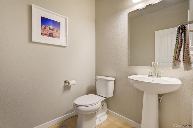 10024 Waterton Canyon Way, Colorado Springs, CO 80924 - bathroom featuring toilet, wood finished floors, and baseboards