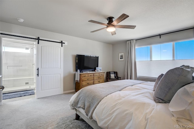 10024 Waterton Canyon Way, Colorado Springs, CO 80924 - bedroom with a barn door, carpet flooring, a ceiling fan, and connected bathroom