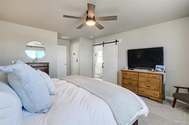 10024 Waterton Canyon Way, Colorado Springs, CO 80924 - bedroom with a barn door, light colored carpet, baseboards, and ceiling fan