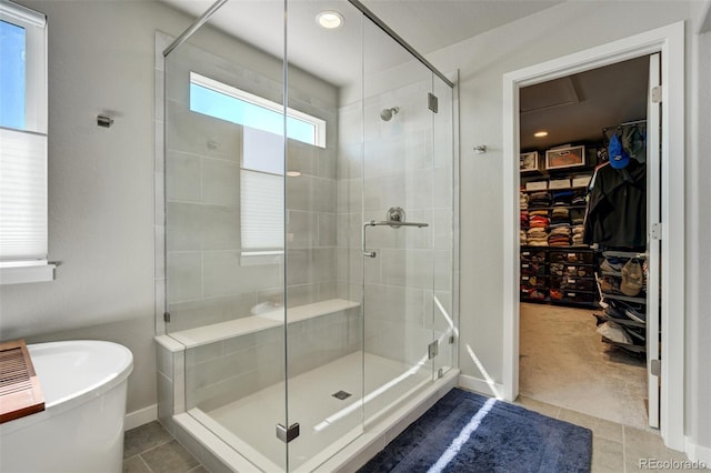 10024 Waterton Canyon Way, Colorado Springs, CO 80924 - bathroom with a shower stall, a walk in closet, a freestanding bath, and tile patterned flooring