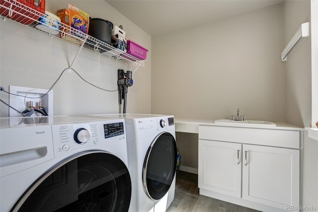 10024 Waterton Canyon Way, Colorado Springs, CO 80924 - laundry room with wood finished floors, washing machine and clothes dryer, a sink, and cabinet space