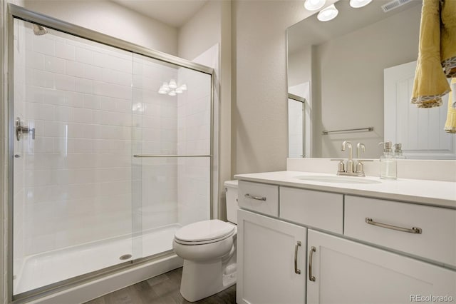 10024 Waterton Canyon Way, Colorado Springs, CO 80924 - full bath featuring a shower stall, vanity, toilet, and wood finished floors