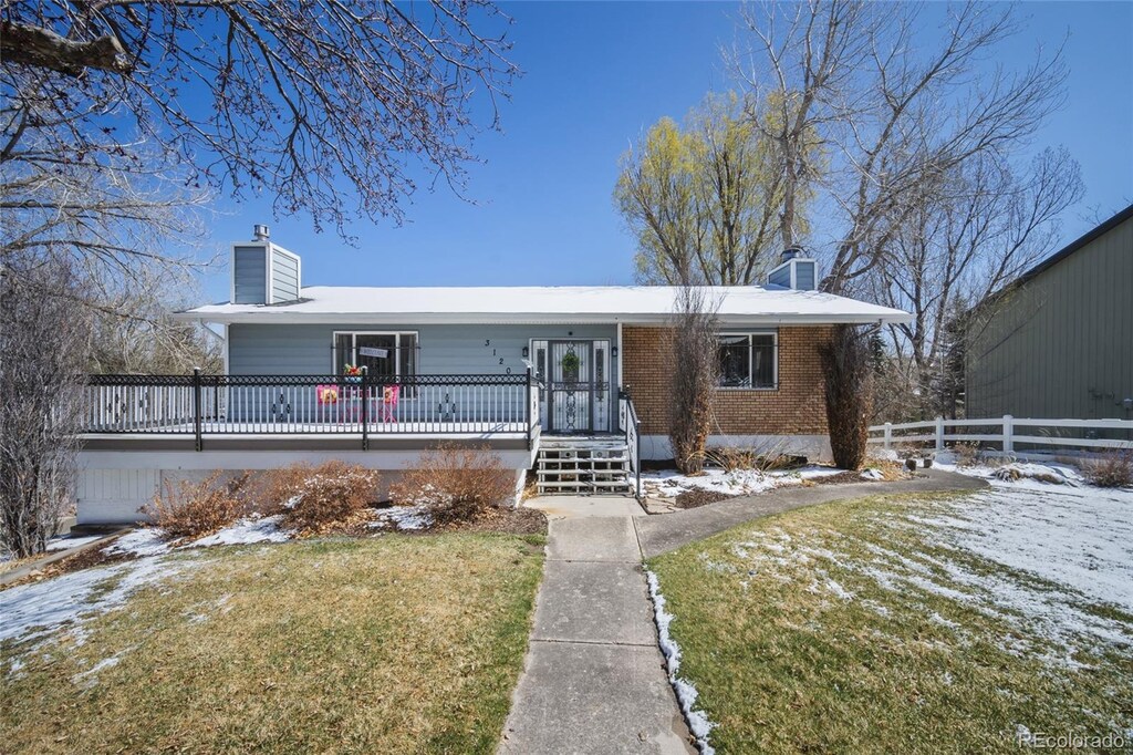 3120 Wesley Pl, Colorado Springs, CO 80917 - ranch-style home featuring a chimney, fence, brick siding, and a yard