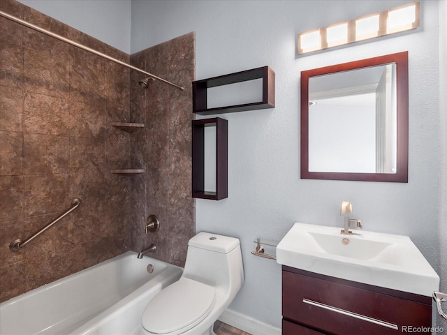 full bathroom featuring tiled shower / bath, vanity, and toilet