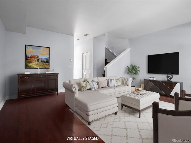 living room with stairway, wood finished floors, visible vents, and baseboards