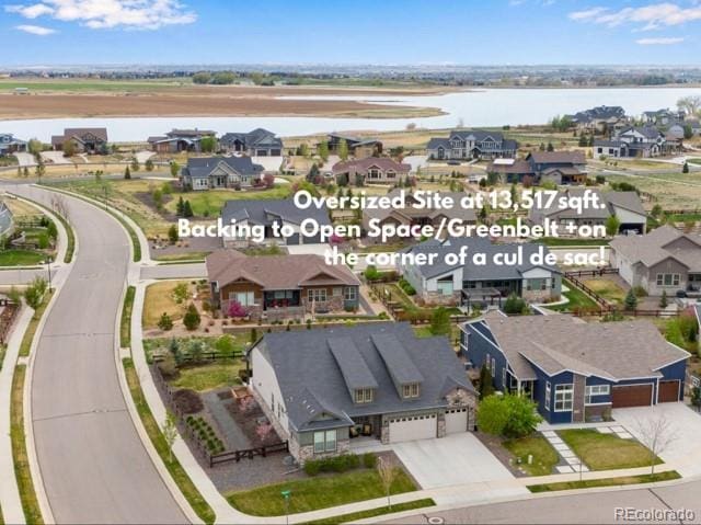 bird's eye view with a water view and a residential view