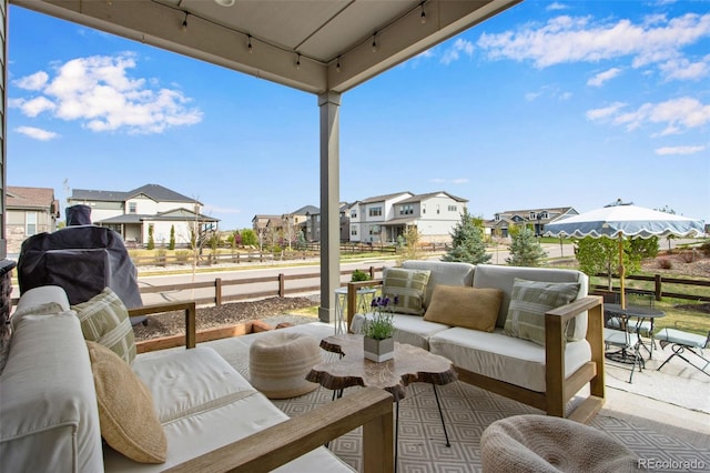 view of patio / terrace with an outdoor hangout area, a residential view, and fence