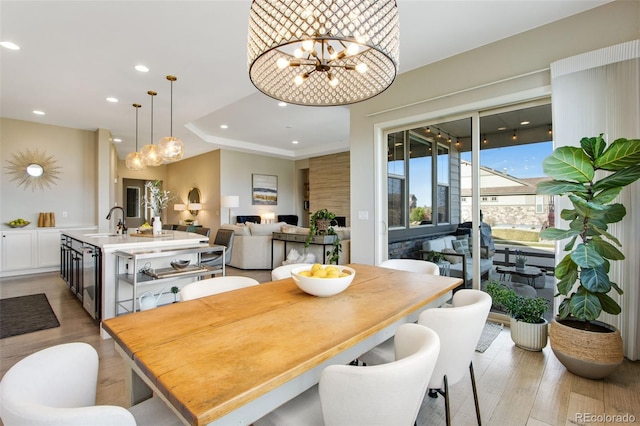 dining room featuring wine cooler, an inviting chandelier, recessed lighting, and light wood-style flooring