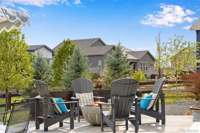 view of patio / terrace with a fire pit and fence
