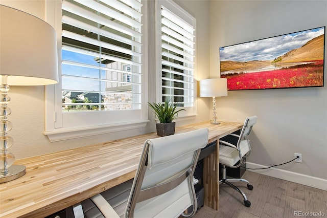 office space featuring built in desk and baseboards