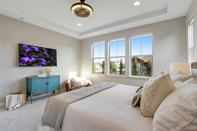 bedroom featuring recessed lighting, baseboards, a tray ceiling, and carpet floors