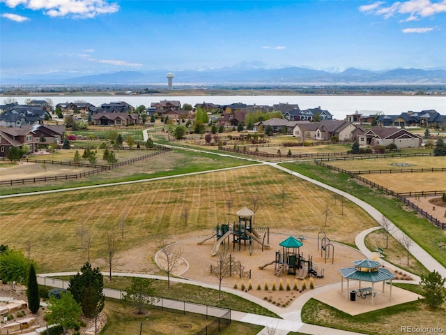 drone / aerial view with a water and mountain view and a residential view