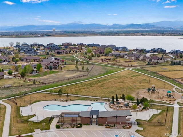 drone / aerial view featuring a water and mountain view